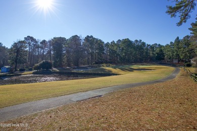 Perfectly positioned on a dog-leg right par five of the Seven on Seven Lakes Country Club in North Carolina - for sale on GolfHomes.com, golf home, golf lot