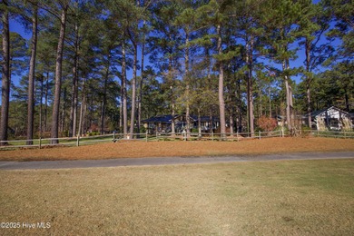Perfectly positioned on a dog-leg right par five of the Seven on Seven Lakes Country Club in North Carolina - for sale on GolfHomes.com, golf home, golf lot