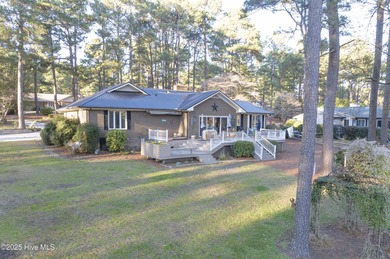 Perfectly positioned on a dog-leg right par five of the Seven on Seven Lakes Country Club in North Carolina - for sale on GolfHomes.com, golf home, golf lot