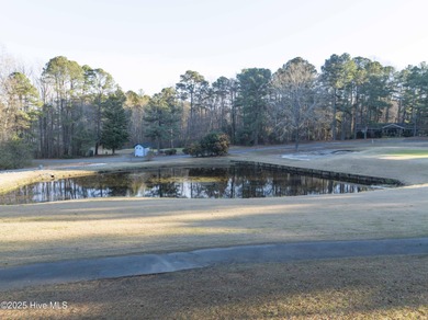 Perfectly positioned on a dog-leg right par five of the Seven on Seven Lakes Country Club in North Carolina - for sale on GolfHomes.com, golf home, golf lot