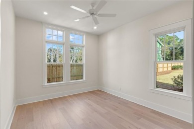 With grays, greens and classic cedar texture, this cottage on Frederica Golf Club in Georgia - for sale on GolfHomes.com, golf home, golf lot