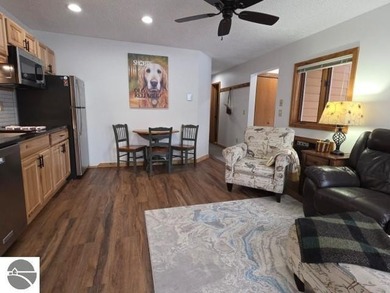Comfortable in all seasons, this 2-bedroom condominium has on  in Michigan - for sale on GolfHomes.com, golf home, golf lot