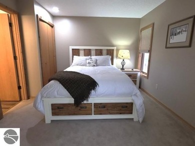 Comfortable in all seasons, this 2-bedroom condominium has on  in Michigan - for sale on GolfHomes.com, golf home, golf lot