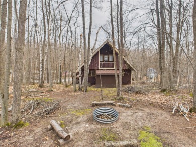 Welcome to this delightful 3-bedroom, 2-bath chalet packed with on Michaywe Pines Course in Michigan - for sale on GolfHomes.com, golf home, golf lot