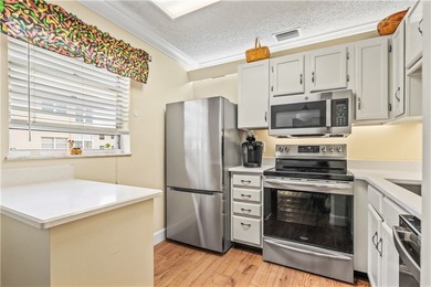 Enjoy easy Florida living in this 2BR/2BA FIRST-FLOOR unit with on The American Golf Club in Florida - for sale on GolfHomes.com, golf home, golf lot