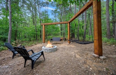 *The Howling Wolf* is a towering getaway cabin at the end of the on Cedar Creek Golf Course At Beavers Bend State Park in Oklahoma - for sale on GolfHomes.com, golf home, golf lot