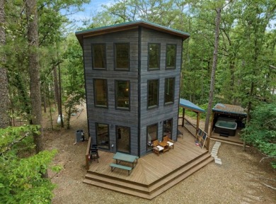 *The Howling Wolf* is a towering getaway cabin at the end of the on Cedar Creek Golf Course At Beavers Bend State Park in Oklahoma - for sale on GolfHomes.com, golf home, golf lot