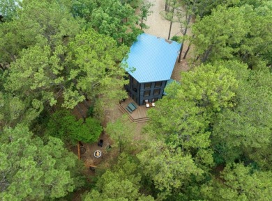 *The Howling Wolf* is a towering getaway cabin at the end of the on Cedar Creek Golf Course At Beavers Bend State Park in Oklahoma - for sale on GolfHomes.com, golf home, golf lot