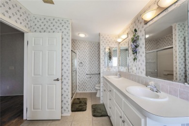 Spacious 2005 Triple-Wide Jacobsen built home situated on a 7 on Maple Leaf Golf and Country Club in Florida - for sale on GolfHomes.com, golf home, golf lot