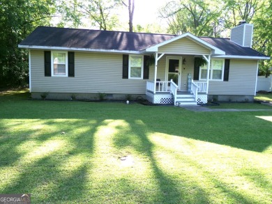 Precious home on level lot with spacious family room anchored by on Golf Club of Macon in Georgia - for sale on GolfHomes.com, golf home, golf lot