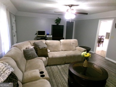 Precious home on level lot with spacious family room anchored by on Golf Club of Macon in Georgia - for sale on GolfHomes.com, golf home, golf lot