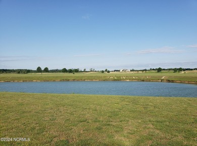 This half-acre low maintenance pond homesite is the lowest on Occano Golf Course in North Carolina - for sale on GolfHomes.com, golf home, golf lot