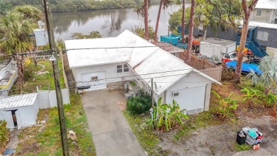 This waterfront property truly presents an incredible on Gulf Harbors Golf Course in Florida - for sale on GolfHomes.com, golf home, golf lot