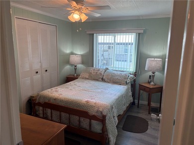 *Home Sweet Home*.Custom painted driveway flows into carport on Barefoot Bay Golf Course in Florida - for sale on GolfHomes.com, golf home, golf lot