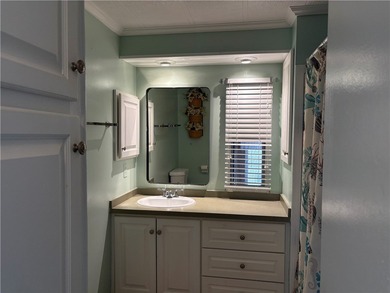 *Home Sweet Home*.Custom painted driveway flows into carport on Barefoot Bay Golf Course in Florida - for sale on GolfHomes.com, golf home, golf lot