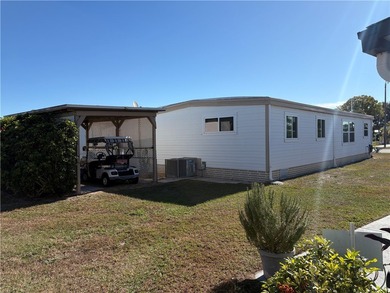 *Home Sweet Home*.Custom painted driveway flows into carport on Barefoot Bay Golf Course in Florida - for sale on GolfHomes.com, golf home, golf lot