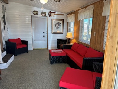 *Home Sweet Home*.Custom painted driveway flows into carport on Barefoot Bay Golf Course in Florida - for sale on GolfHomes.com, golf home, golf lot