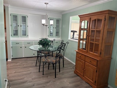 *Home Sweet Home*.Custom painted driveway flows into carport on Barefoot Bay Golf Course in Florida - for sale on GolfHomes.com, golf home, golf lot