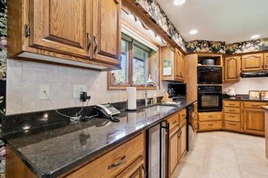 Step into timeless elegance with this beautifully crafted home on Waukon Golf and Country Club in Iowa - for sale on GolfHomes.com, golf home, golf lot