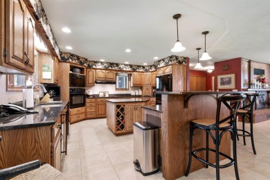 Step into timeless elegance with this beautifully crafted home on Waukon Golf and Country Club in Iowa - for sale on GolfHomes.com, golf home, golf lot
