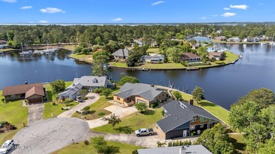 Experience unparalleled waterfront living in this waterfront on Harbour Point Golf Club in North Carolina - for sale on GolfHomes.com, golf home, golf lot