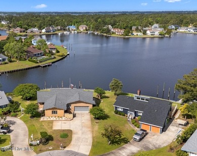 Experience unparalleled waterfront living in this waterfront on Harbour Point Golf Club in North Carolina - for sale on GolfHomes.com, golf home, golf lot