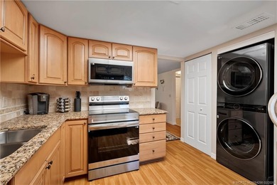 This spectacular furnished turnkey first-floor 2BR/2BA residence on Miles Grant Country Club in Florida - for sale on GolfHomes.com, golf home, golf lot