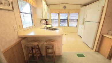 TURNKEY MOBILE HOME IN ACTIVE 55+ COMMUNITY! This one bedroom, 1 on River Run Golf Links in Florida - for sale on GolfHomes.com, golf home, golf lot