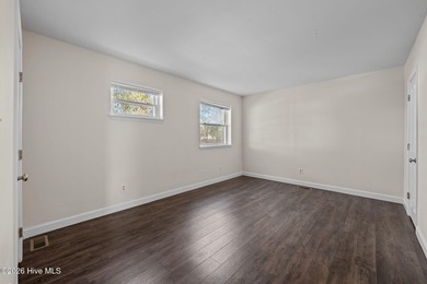 What a deal! Welcome to this 3-bedroom, 2-bath contemporary on Harbour Point Golf Club in North Carolina - for sale on GolfHomes.com, golf home, golf lot