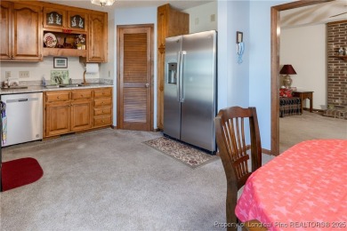 Welcome to this charming 3-bedroom, 2.5-bath home on Hole One of on Sandy Ridge Country Club in North Carolina - for sale on GolfHomes.com, golf home, golf lot
