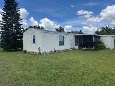 Welcome home to this lovely 2-bedroom, 2-bath oasis in the 55+ on Lake Henry Golf Club in Florida - for sale on GolfHomes.com, golf home, golf lot