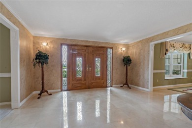 Step into timeless elegance in this stunning Colonial-style on Feather Sound Country Club in Florida - for sale on GolfHomes.com, golf home, golf lot