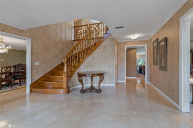 Step into timeless elegance in this stunning Colonial-style on Feather Sound Country Club in Florida - for sale on GolfHomes.com, golf home, golf lot