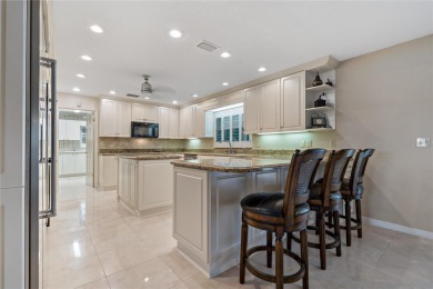 Step into timeless elegance in this stunning Colonial-style on Feather Sound Country Club in Florida - for sale on GolfHomes.com, golf home, golf lot