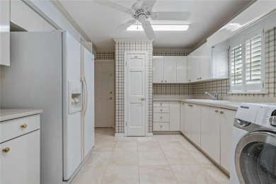 Step into timeless elegance in this stunning Colonial-style on Feather Sound Country Club in Florida - for sale on GolfHomes.com, golf home, golf lot