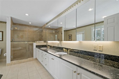 Step into timeless elegance in this stunning Colonial-style on Feather Sound Country Club in Florida - for sale on GolfHomes.com, golf home, golf lot