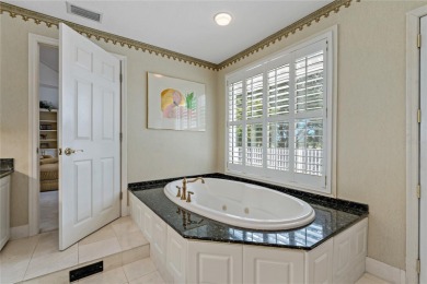 Step into timeless elegance in this stunning Colonial-style on Feather Sound Country Club in Florida - for sale on GolfHomes.com, golf home, golf lot