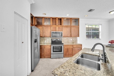 Elegant two-story residence located in the highly sought-after on Palm-Aire Country Club and Resort - The Oaks in Florida - for sale on GolfHomes.com, golf home, golf lot