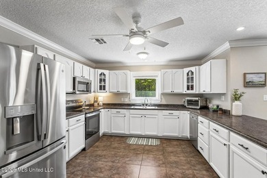 Situated on a spacious double lot in the desirable Diamondhead on Diamondhead Country Club in Mississippi - for sale on GolfHomes.com, golf home, golf lot