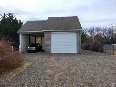 Lake living usually encourages boat, jet ski, golf cart, SXS on Lake Perry Country Club in Kansas - for sale on GolfHomes.com, golf home, golf lot