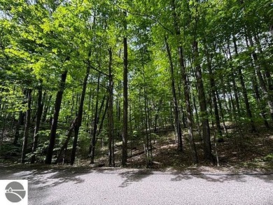 Go beyond the gated entrance, where a wooded winding drive on  in Michigan - for sale on GolfHomes.com, golf home, golf lot
