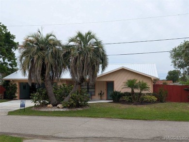 This house is located less than 1000 ft. from Three Sisters on Plantation Inn and Golf Resort  in Florida - for sale on GolfHomes.com, golf home, golf lot