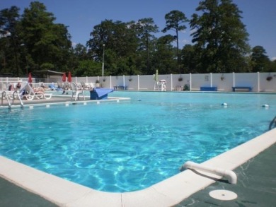 Lot with camper, camperport, deck, and shed.  Camper is in good on Captains Cove Golf and Yacht Club in Virginia - for sale on GolfHomes.com, golf home, golf lot