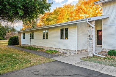 This first-floor unit offers a large living room with vaulted on Bay Ridge Golf Course in Wisconsin - for sale on GolfHomes.com, golf home, golf lot