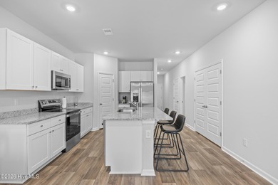 Elegantly appointed resale townhome located in The Hamptons at on Brunswick Plantation and Golf Resorts in North Carolina - for sale on GolfHomes.com, golf home, golf lot