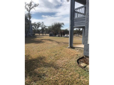 This unit is on the bottom floor, with the back door opening on Rockport Country Club in Texas - for sale on GolfHomes.com, golf home, golf lot