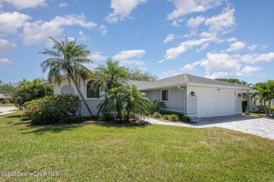 Gorgeous paver driveway and lush landscaping greet you as you on Indian River Colony Club in Florida - for sale on GolfHomes.com, golf home, golf lot