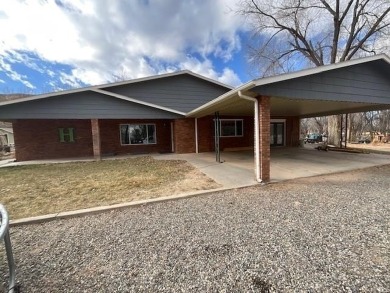 Nestled under the Colorado National Monument, with on Tiara Rado Golf Course in Colorado - for sale on GolfHomes.com, golf home, golf lot