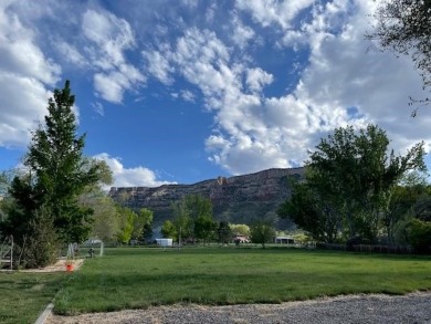 Nestled under the Colorado National Monument, with on Tiara Rado Golf Course in Colorado - for sale on GolfHomes.com, golf home, golf lot