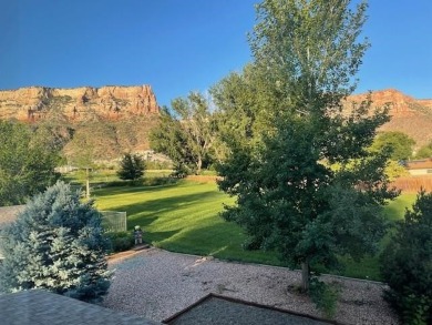 Nestled under the Colorado National Monument, with on Tiara Rado Golf Course in Colorado - for sale on GolfHomes.com, golf home, golf lot